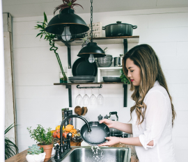 A maid washes the dishes